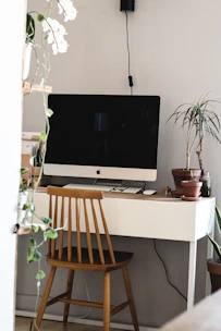 Modern minimalist workspace with golden accents and high-tech devices on matte black surface.