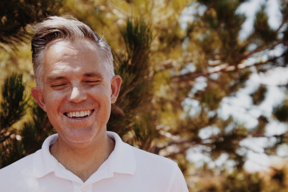 smiling man in white dress shirt