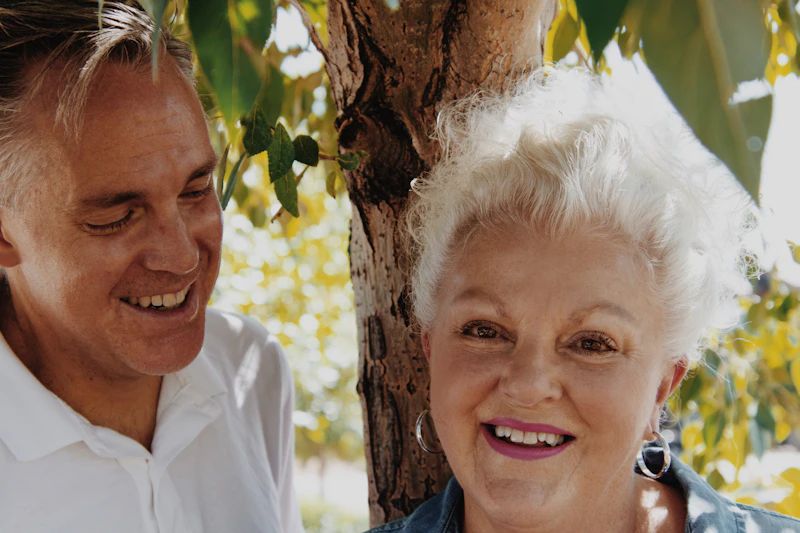 Smiling senior couple in white and blue shirts