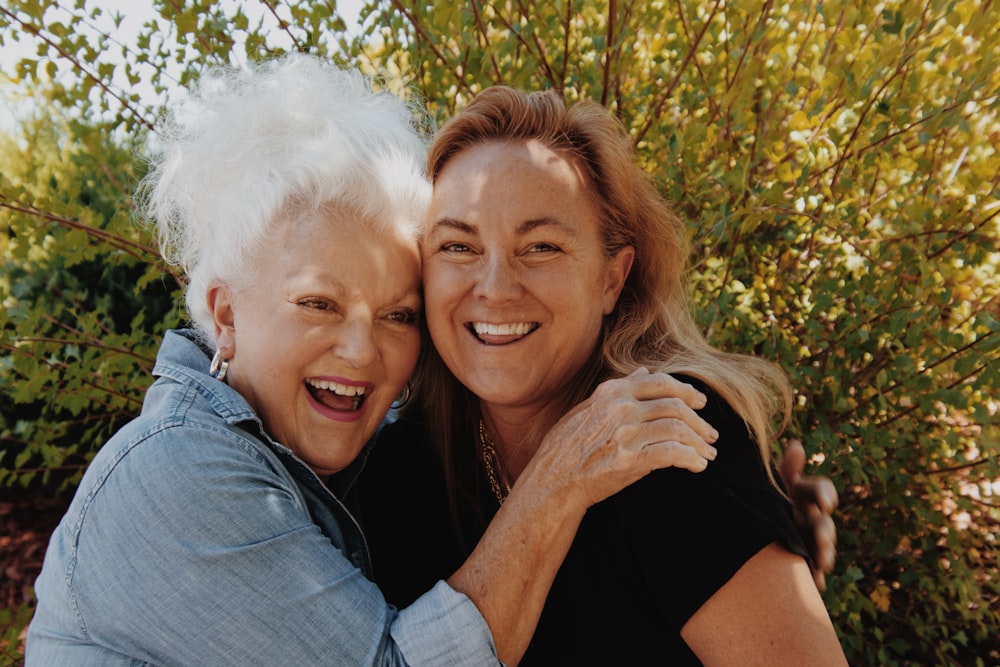 woman in black shirt hugging woman in black shirt