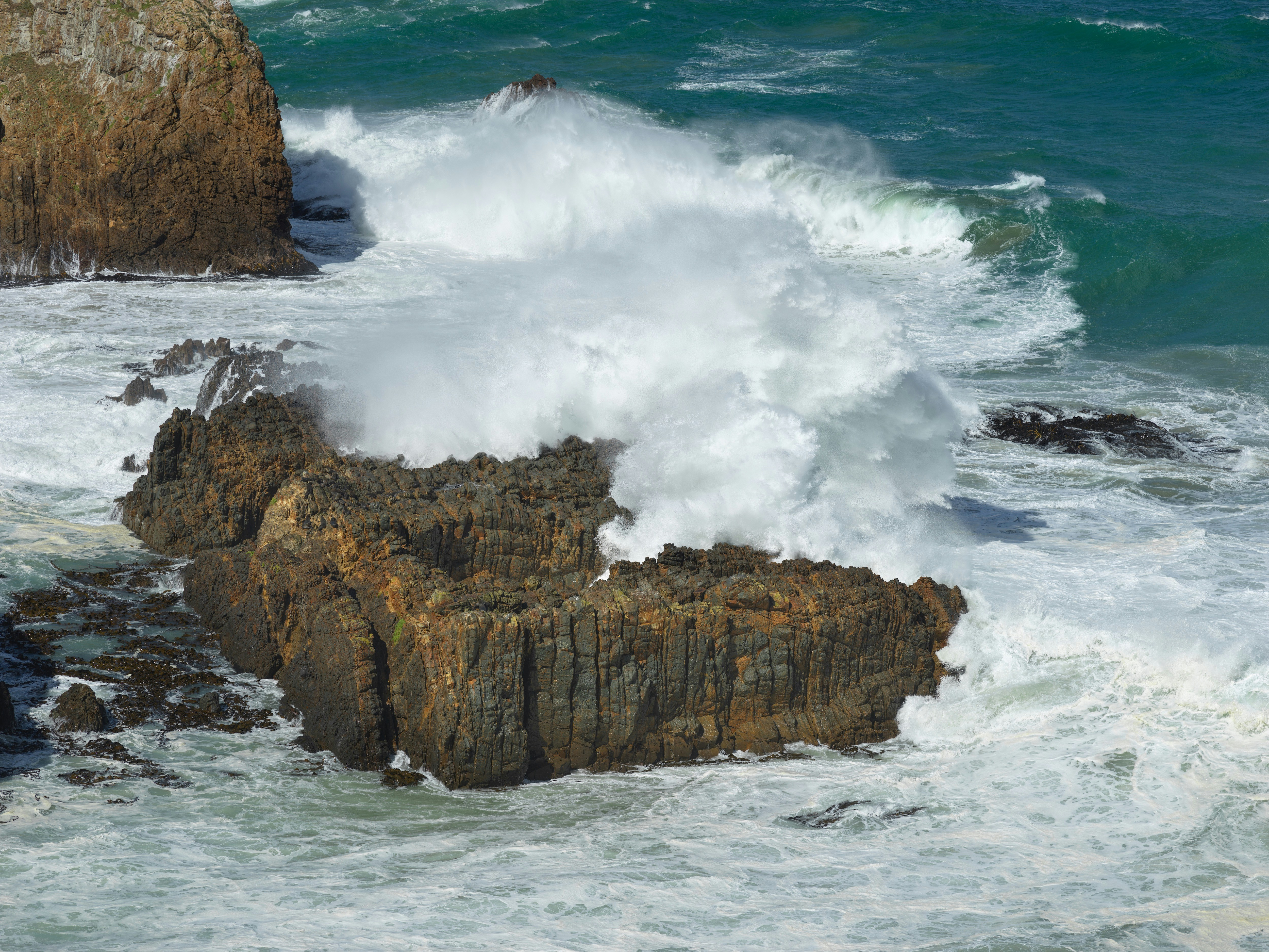 brown rock formation on sea during daytime