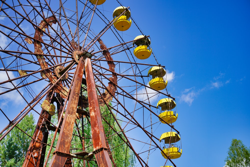 brown wooden ferris wheel under blue sky during daytime