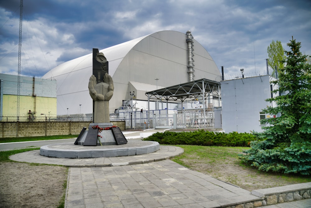 gray statue near white building during daytime