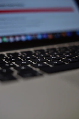 Close-up of a laptop keyboard with screen blurred