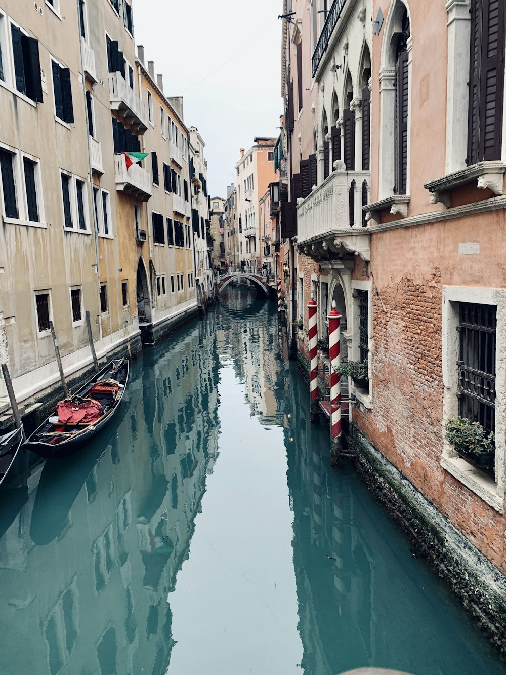 boat on river between buildings during daytime