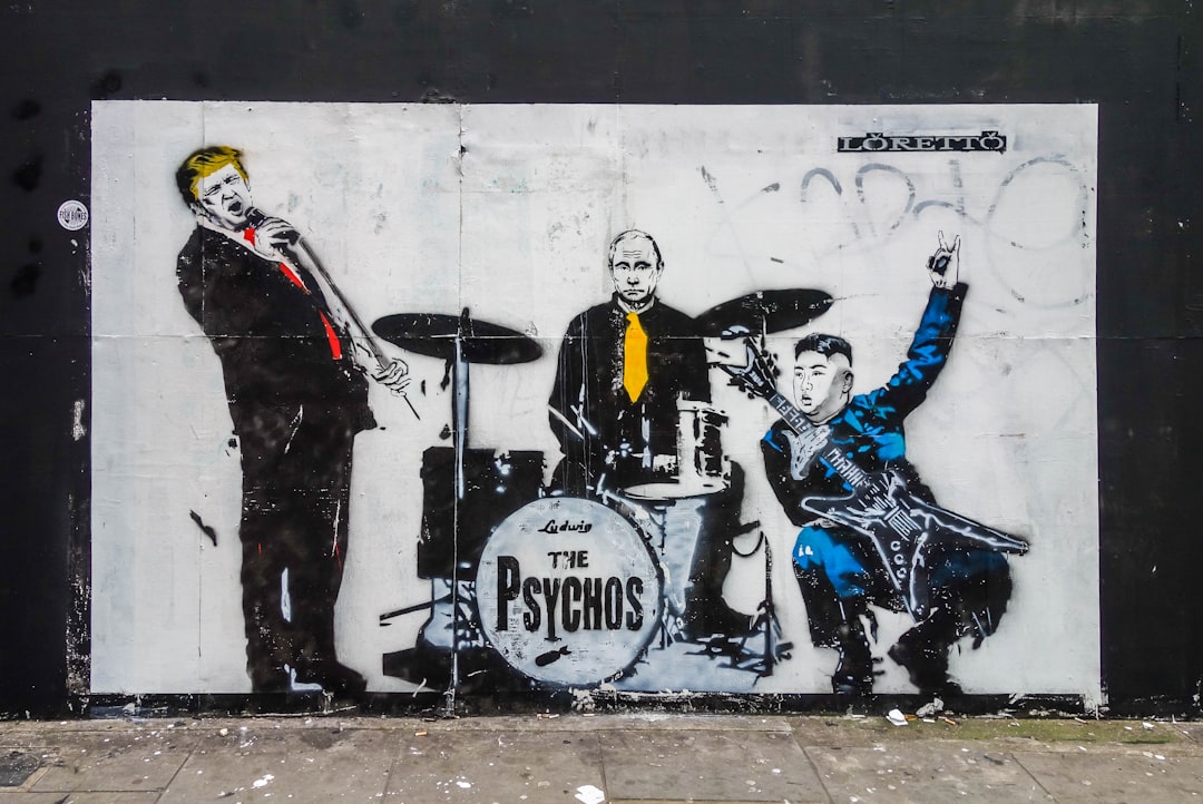 man in black and yellow jacket riding on white horse, Graffiti in Spitalfields London