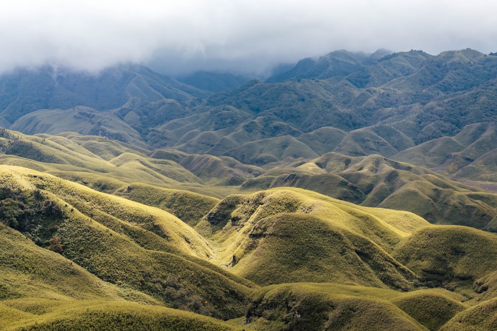 green and brown mountains under white clouds during daytime