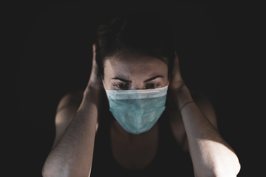 woman covering her face with teal paint