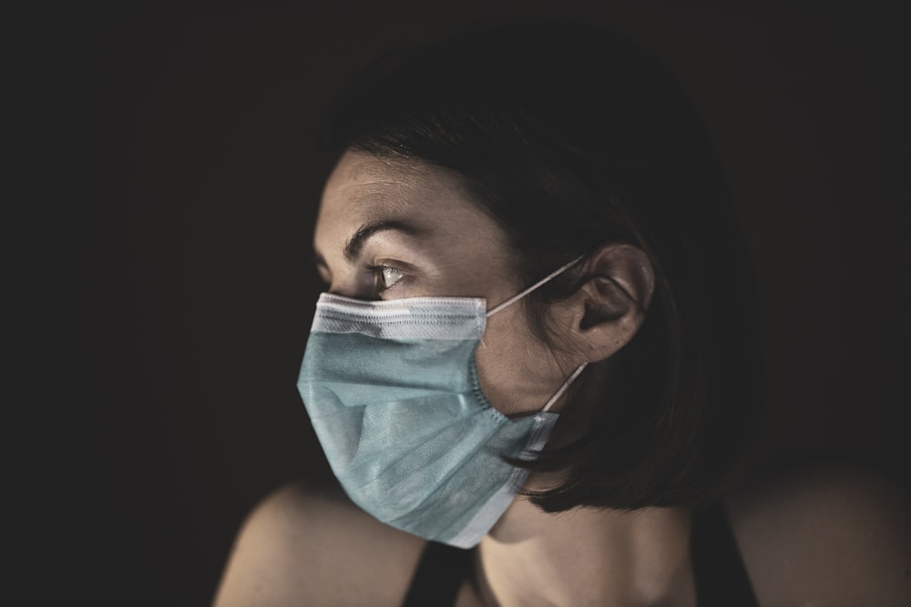 woman covering her face with blue and white textile