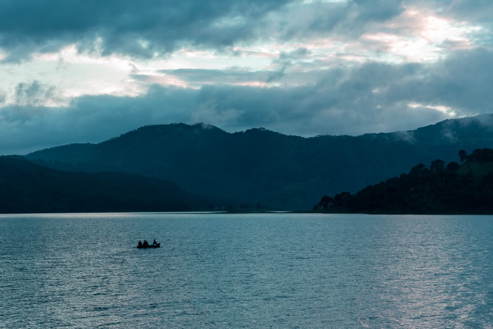 2 people riding on boat on sea during daytime