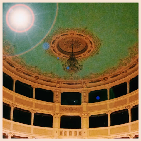 Elegant stage setting with vintage opera posters of Cavalleria Rusticana in warm lighting