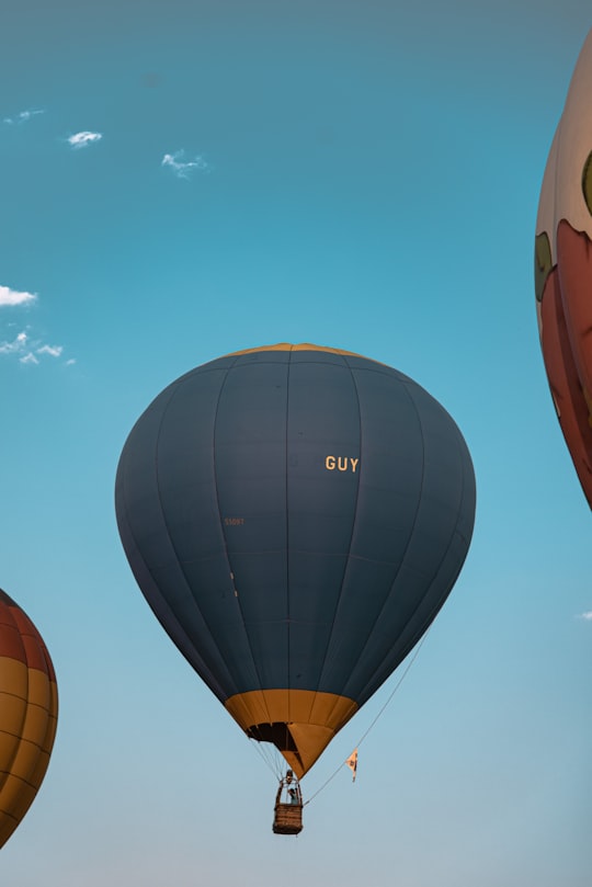 blue hot air balloon under blue sky during daytime in Chiang Rai Thailand