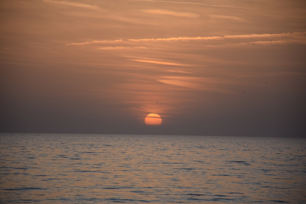 body of water during sunset