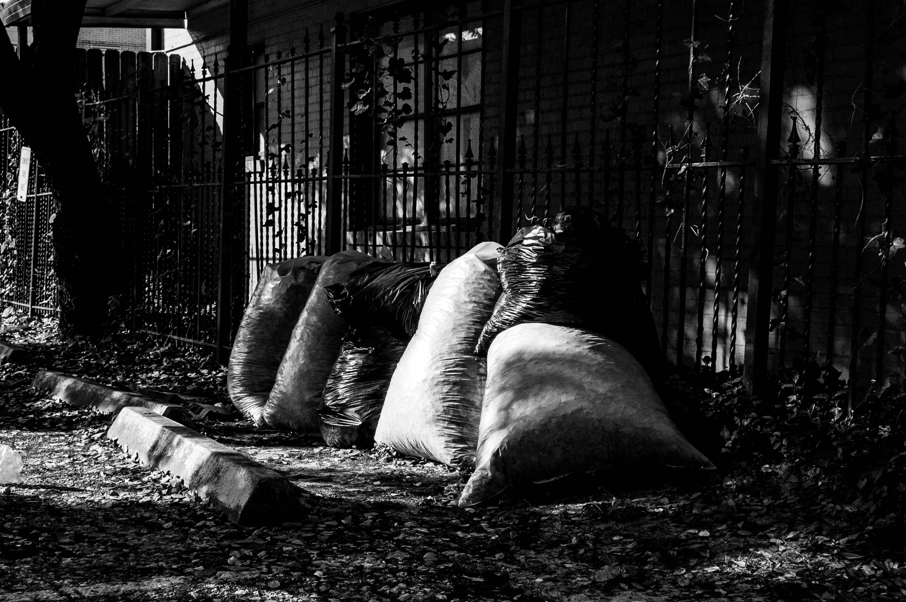 grayscale photo of man lying on rock