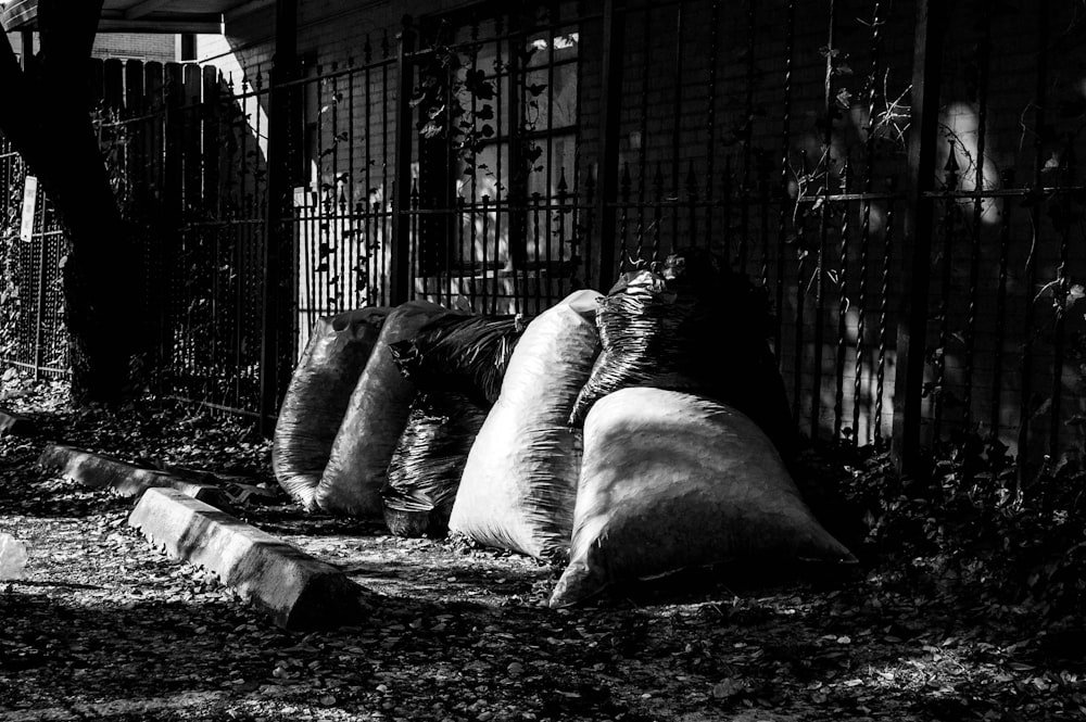 grayscale photo of man lying on rock