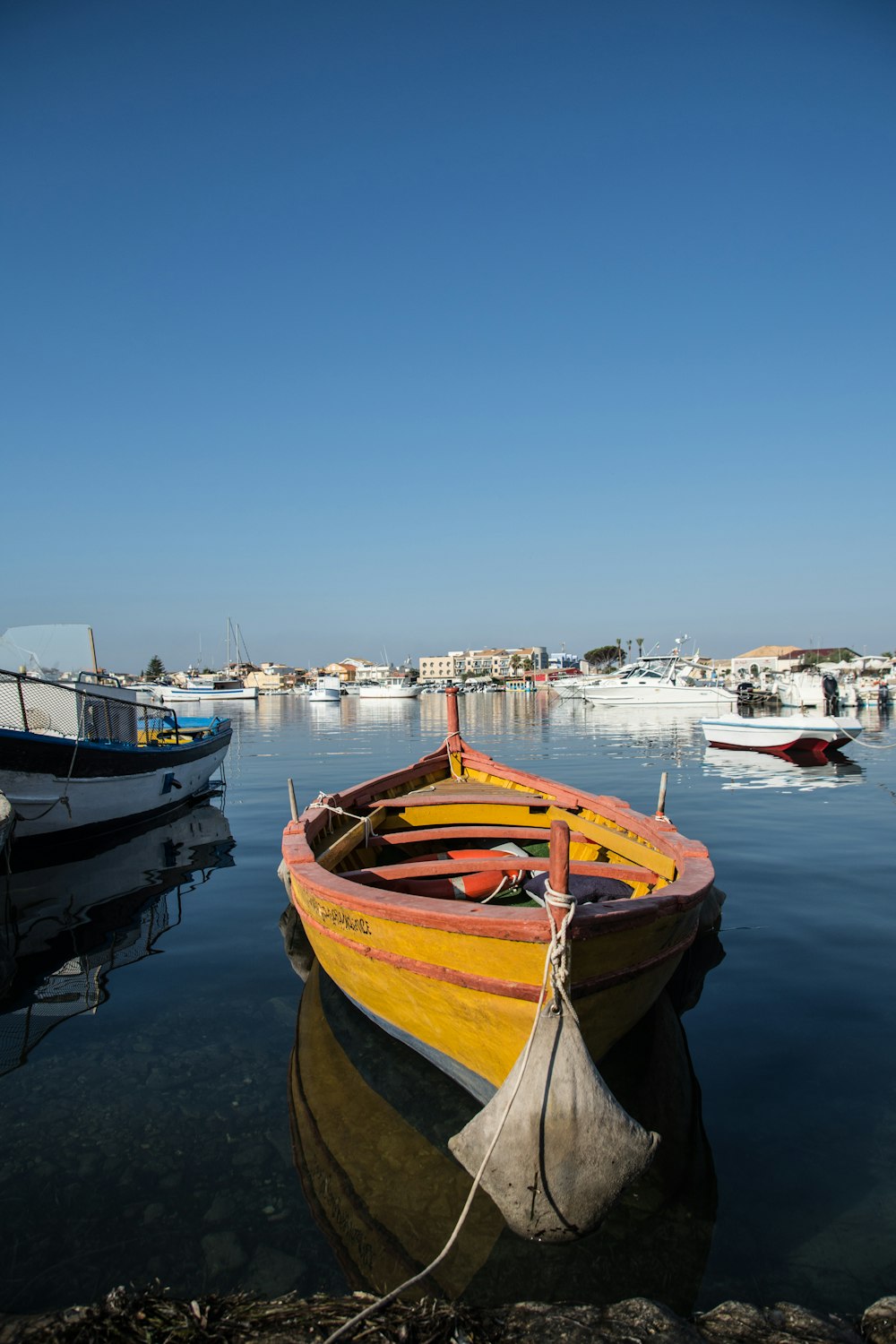 brown and white boat on dock during daytime