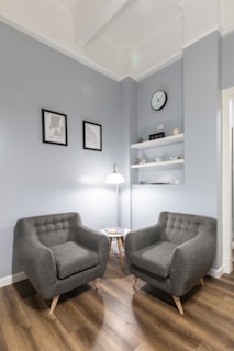 gray sofa chair beside white floor lamp