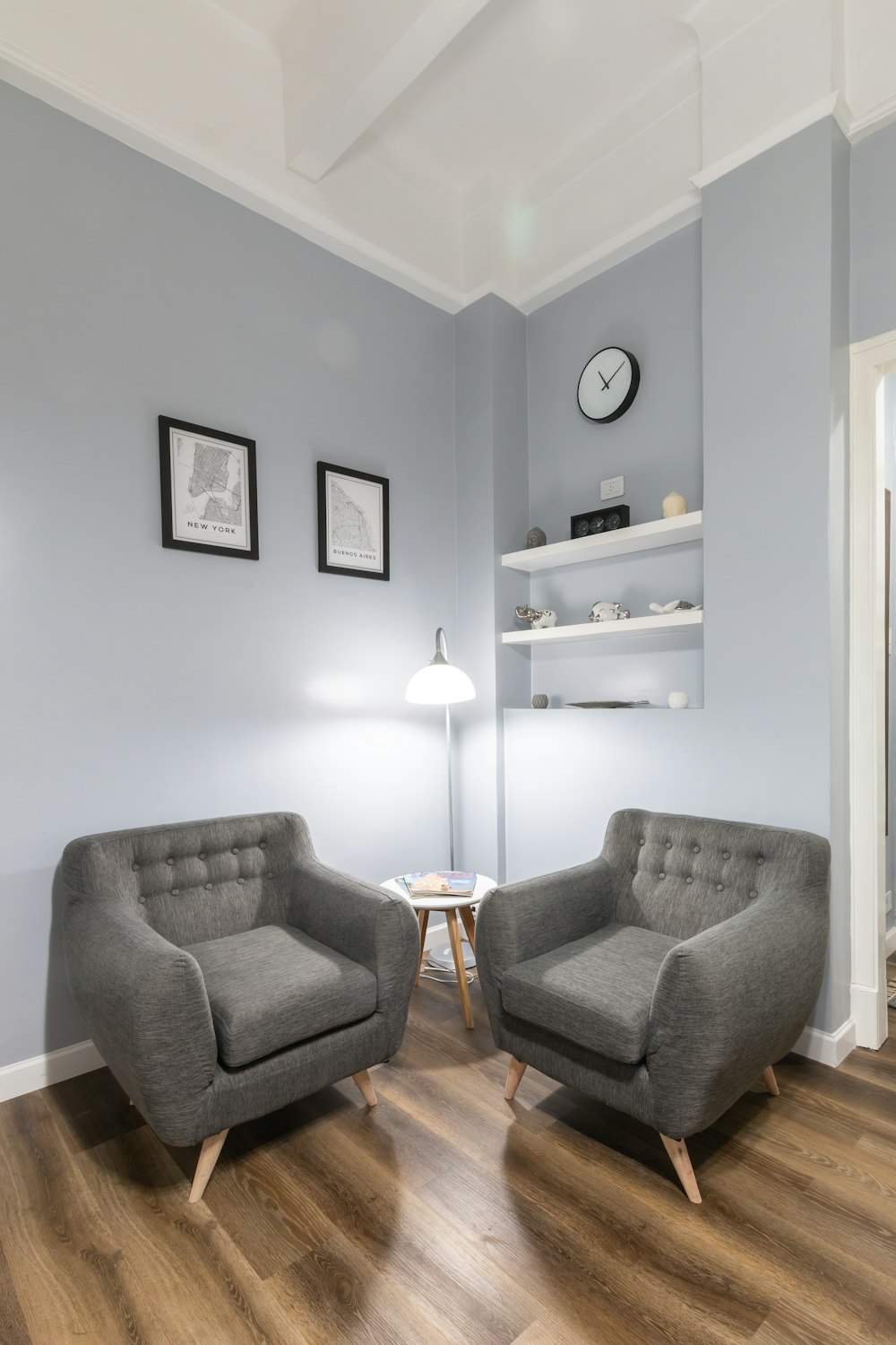 gray sofa chair beside white floor lamp
