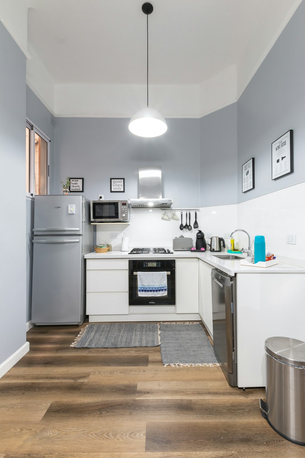 white top mount refrigerator beside white wall