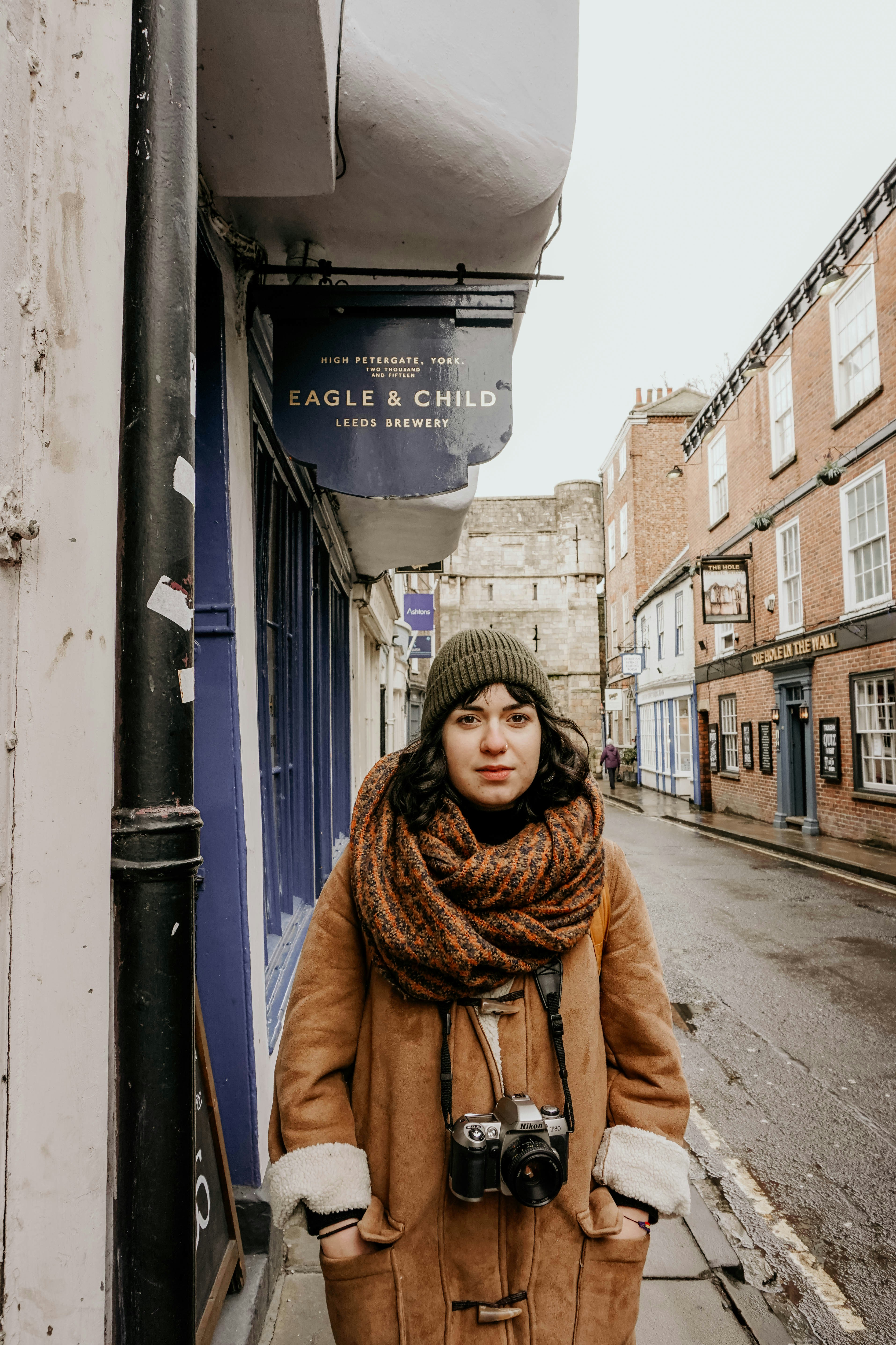 Woman in brown coat standing on sidewalk during daytime photo – Free ...