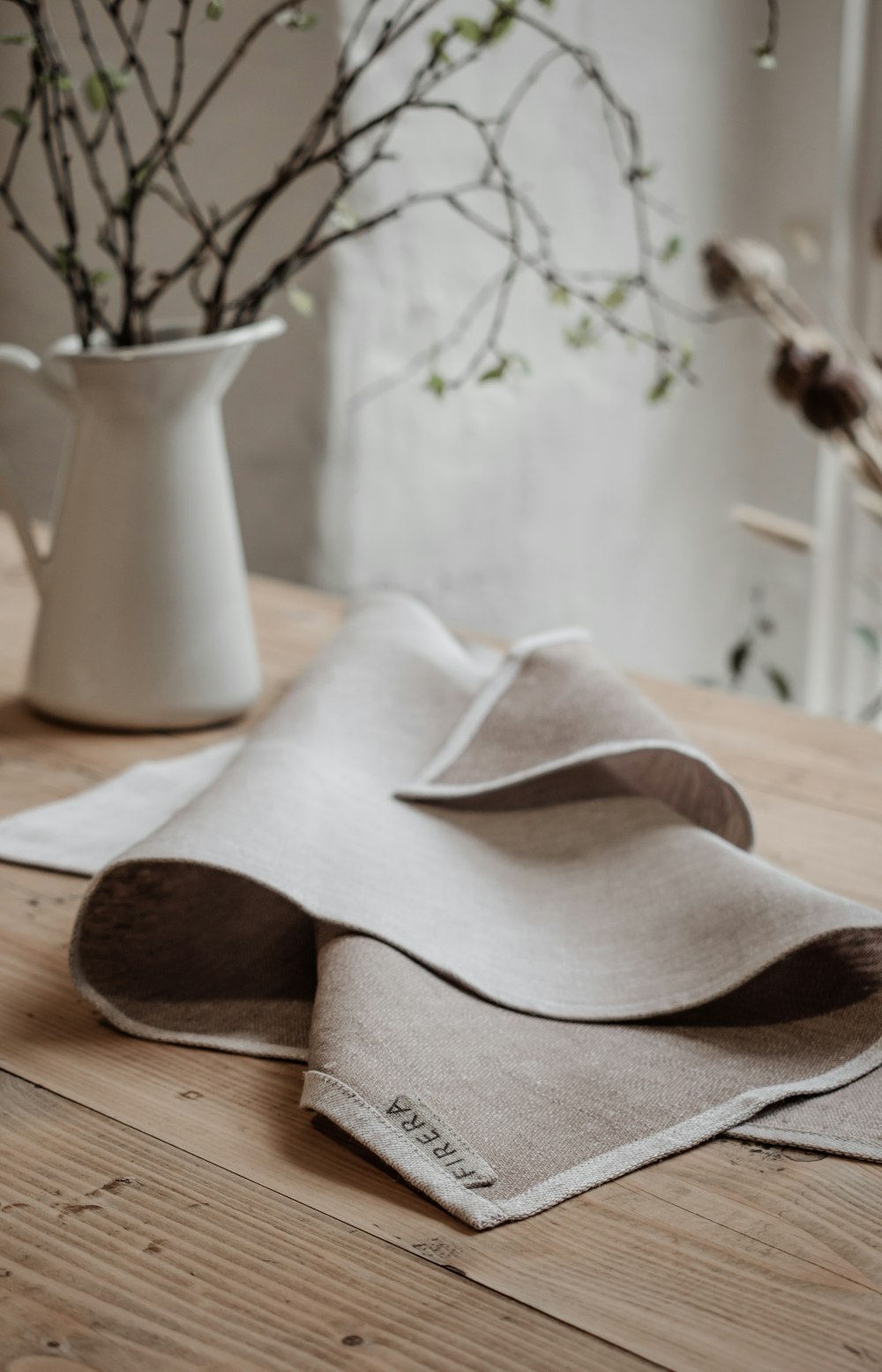 white ceramic vase on brown wooden table