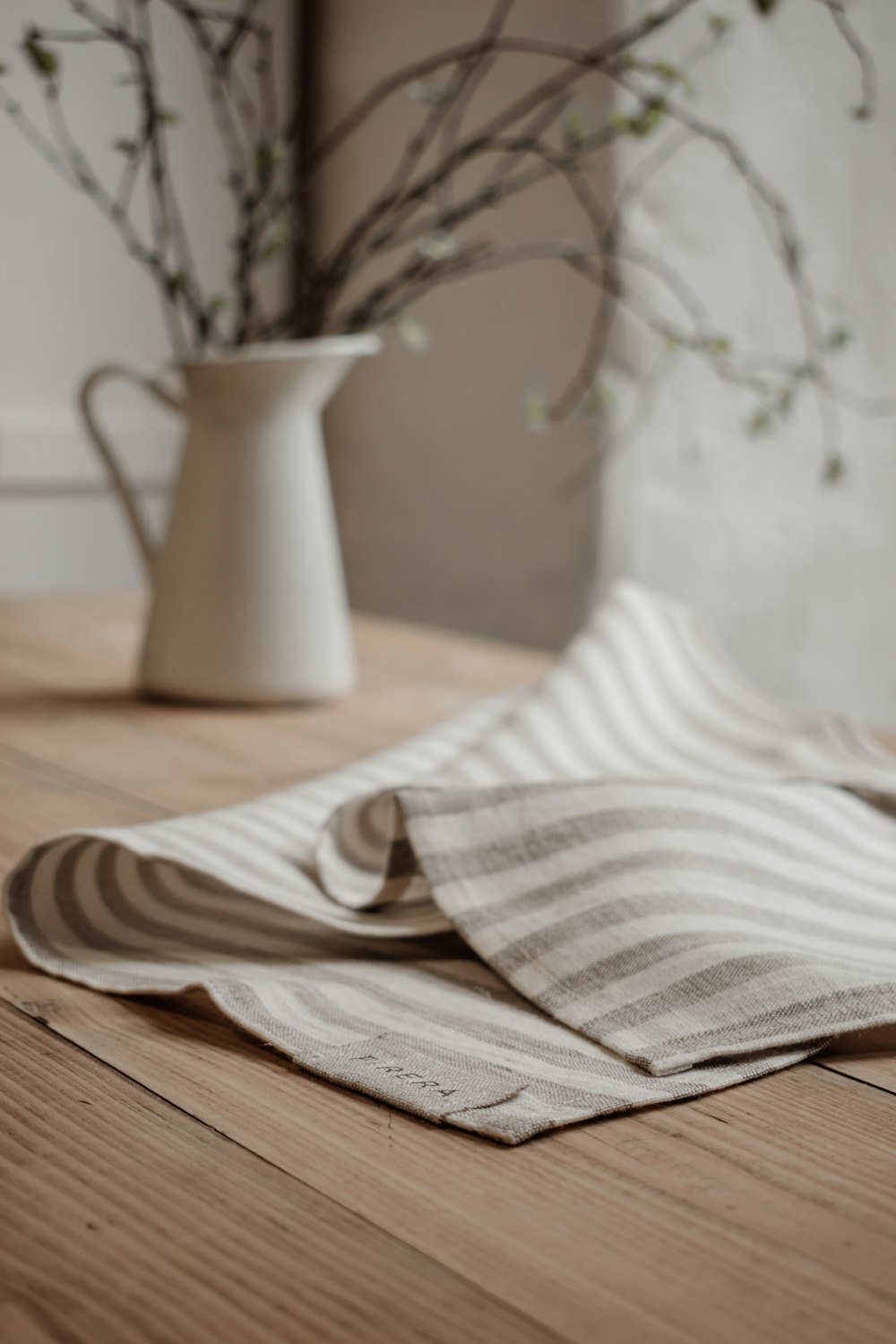 white and brown stripe textile on brown wooden table