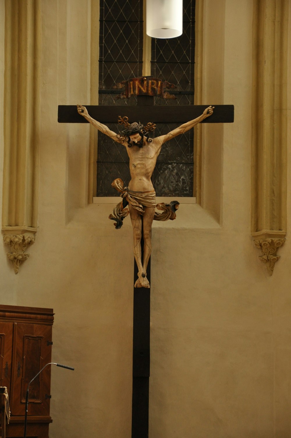 black crucifix on white wall