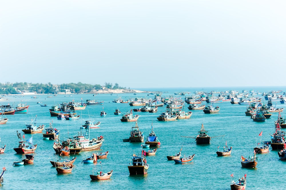 white and blue boats on sea during daytime