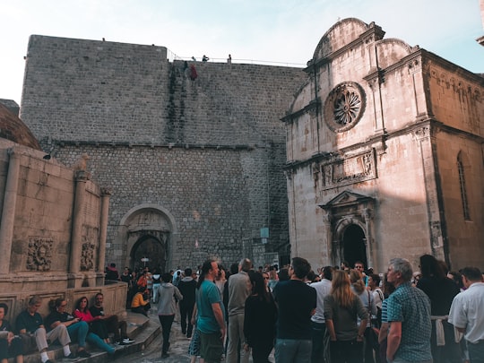 people standing near gray concrete building during daytime in Muralles de Dubrovnik Croatia