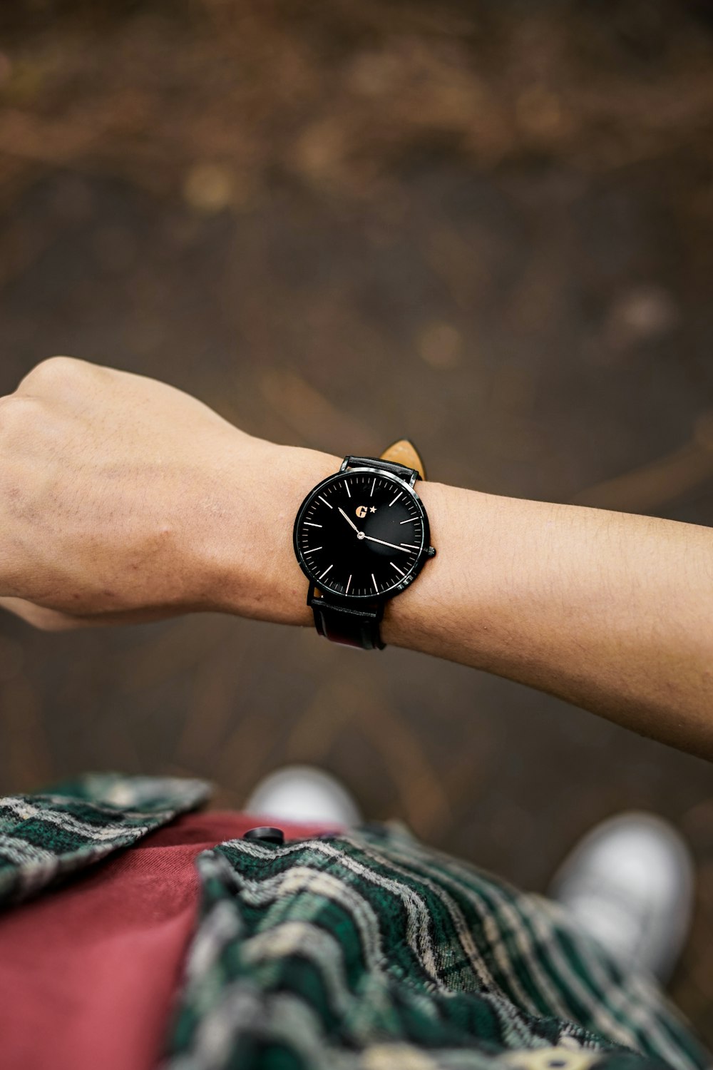 person wearing black and gold analog watch
