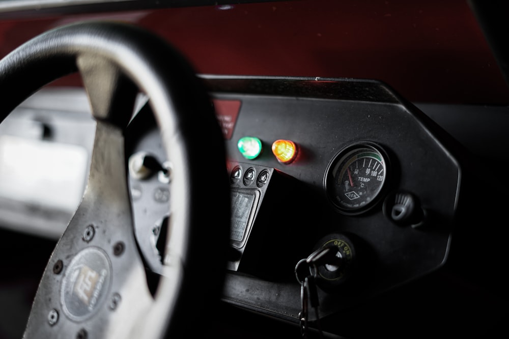 black car steering wheel and red car
