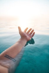 person wearing black watch and green bracelet