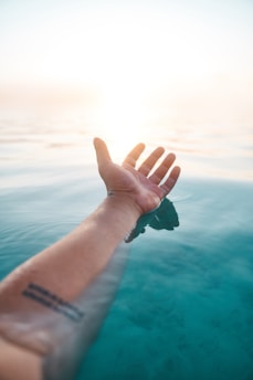 person wearing black watch and green bracelet
