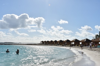 A happy family enjoying a tropical beach vacation with clear turquoise water.
