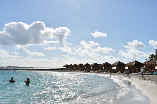 A happy family enjoying a tropical beach vacation with clear turquoise water.