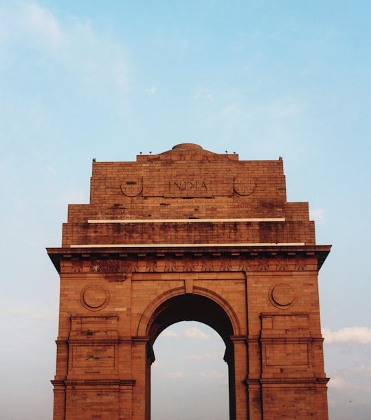 brown concrete building under white sky during daytime in India Gate India