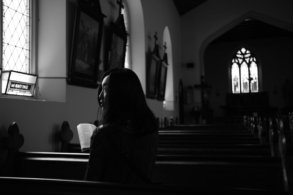 woman in black and white long sleeve shirt sitting on bench