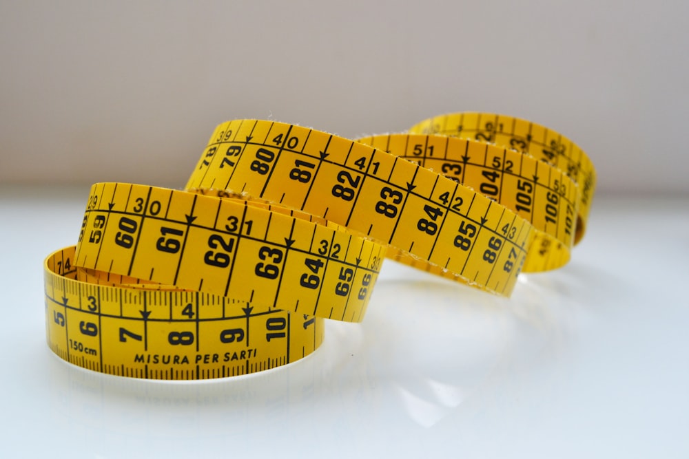 White Measurement Tape Roll With Number Of Centimeter And Inch In The Other  Side On White Background With Copy Space Using As Health Diet Or Measuring  Tool Concept Stock Photo - Download