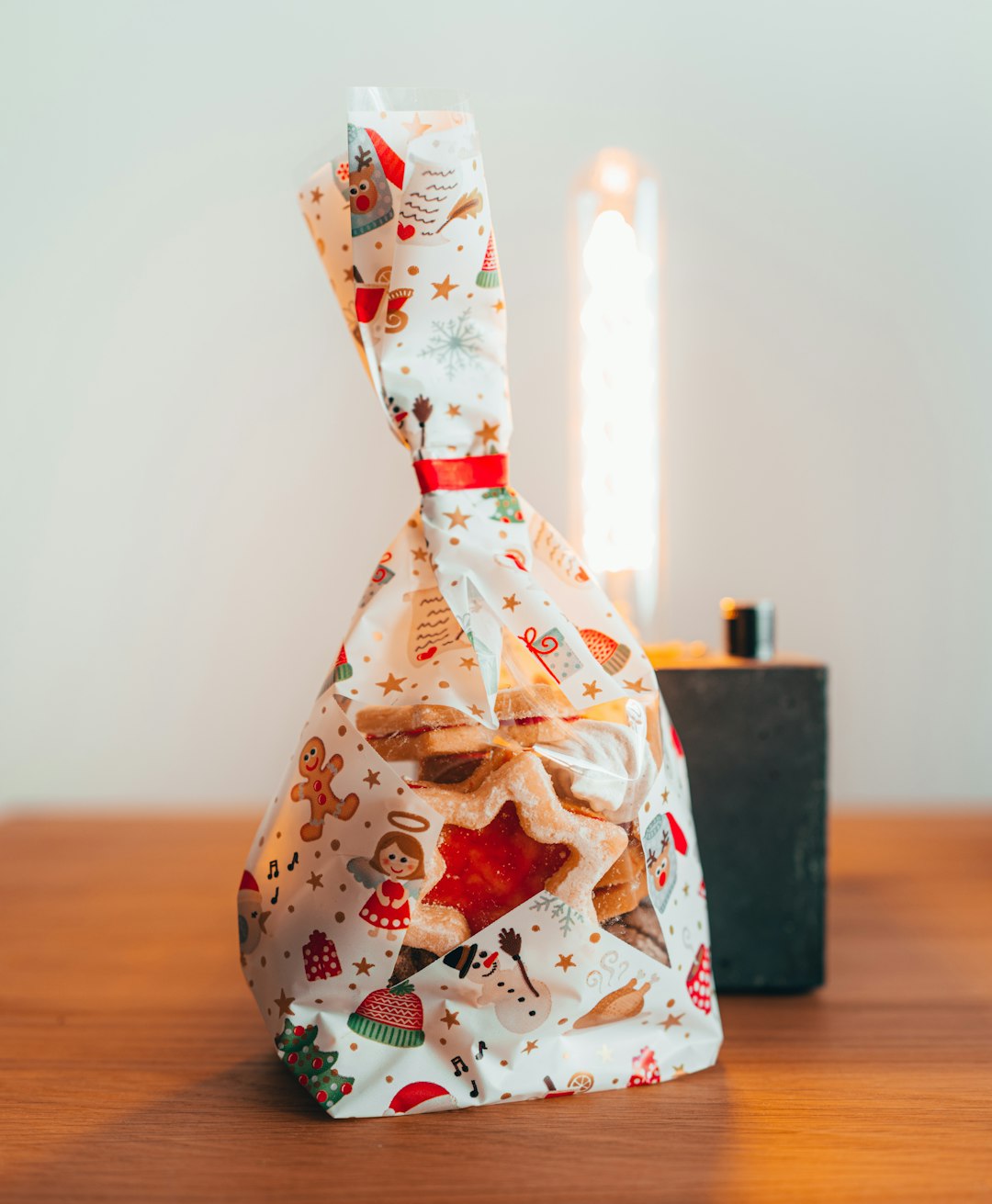 white and red floral gift wrapper on brown wooden table