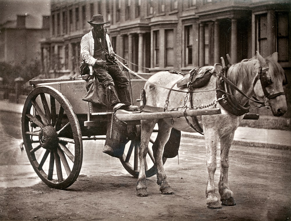 Foto in scala di grigi di un uomo che cavalca un cavallo