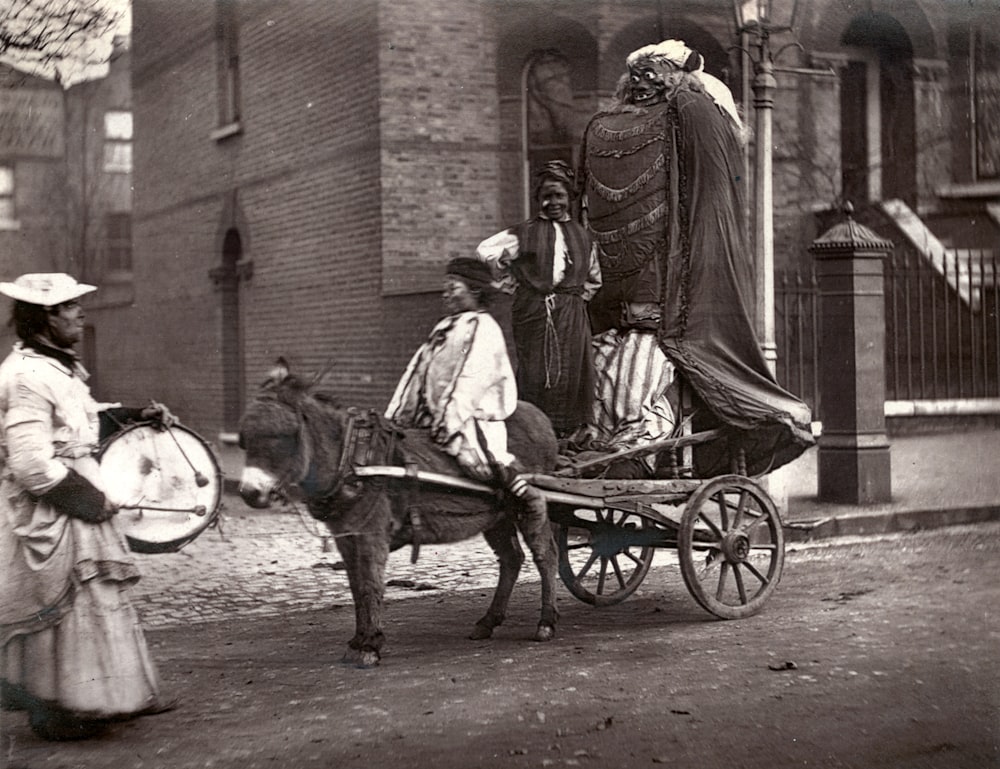 grayscale photo of man riding horse