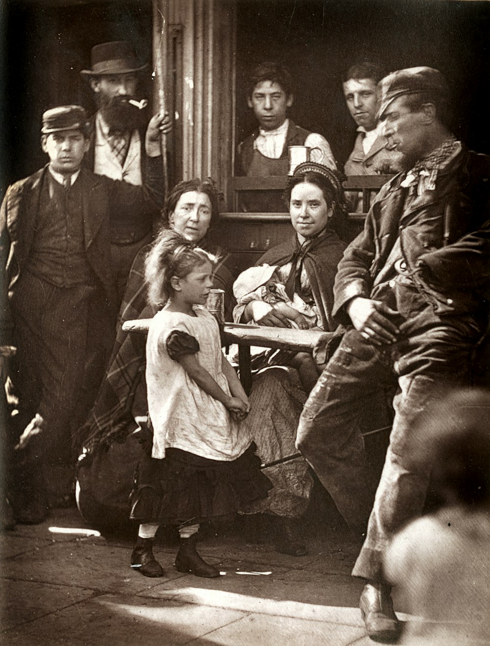 grayscale photo of man and woman with children