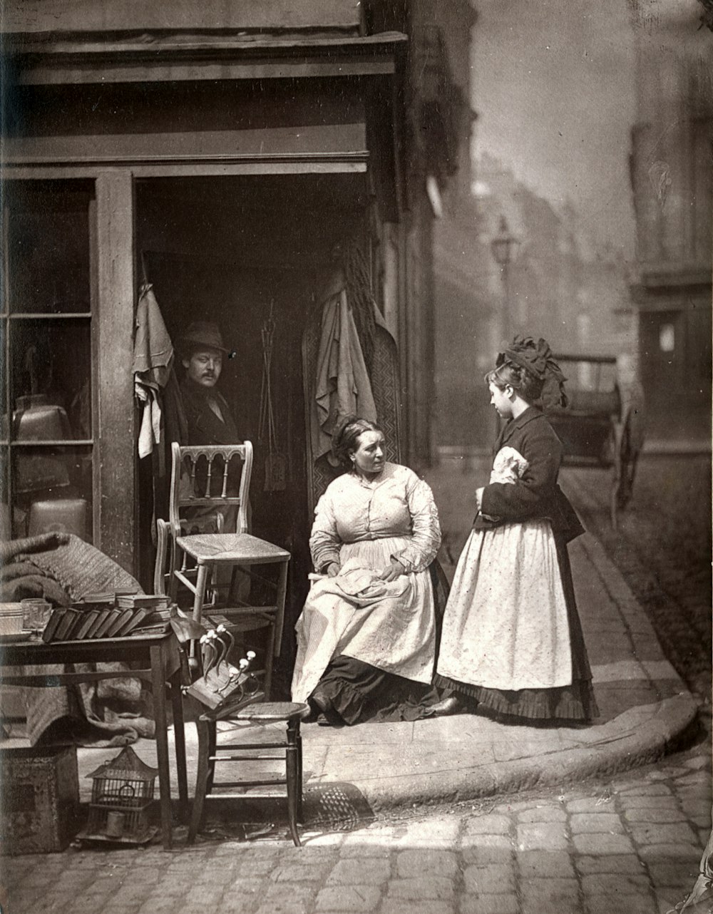 grayscale photo of girl and boy sitting on chair