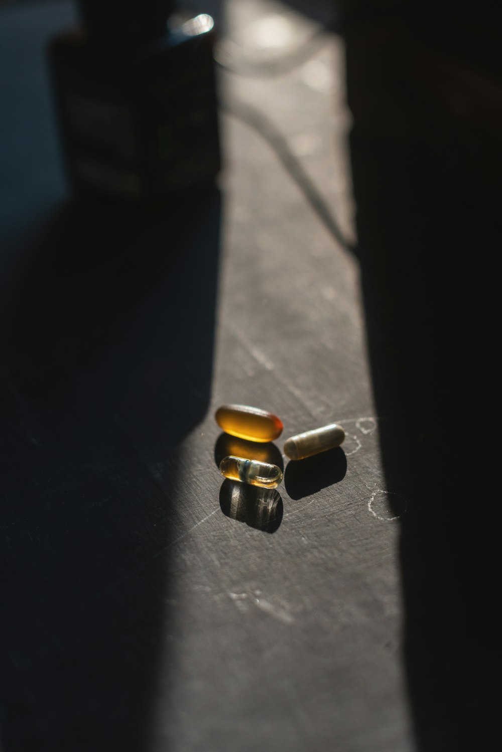 brown and black medicine tablets on black surface