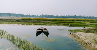 a couple of boats floating on top of a lake