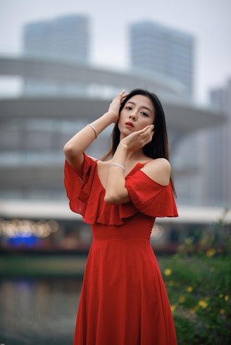 Woman wearing elegant red dress in urban setting