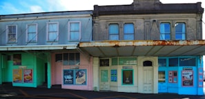 Before and after shots of a weathered storefront transformed with a fresh coat of paint