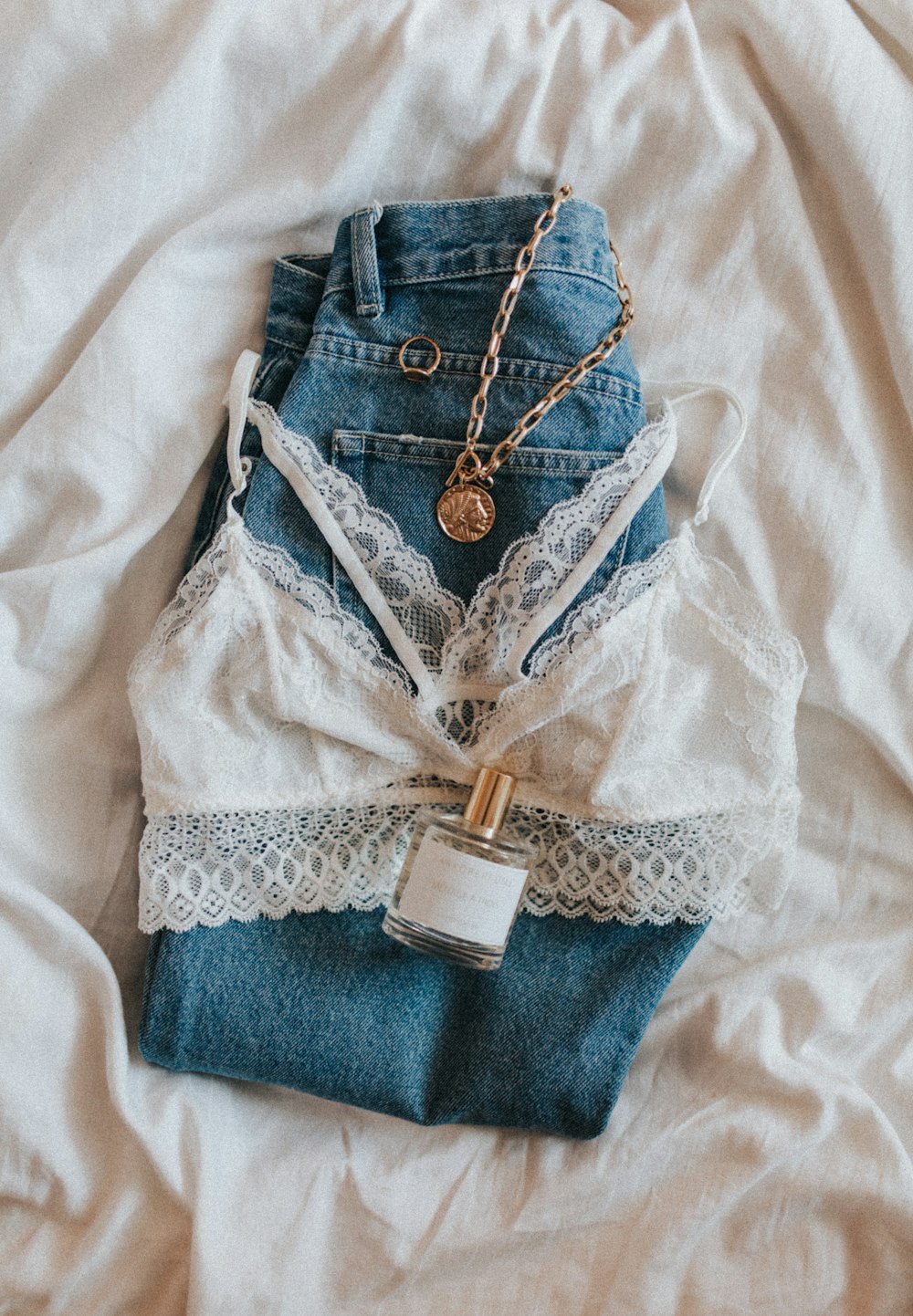blue denim jeans with gold necklace