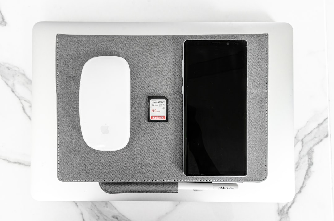 white apple magic mouse on black and gray speaker