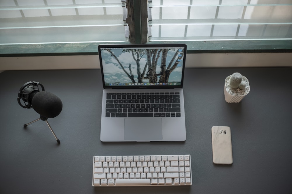 macbook pro beside apple magic keyboard and apple magic mouse